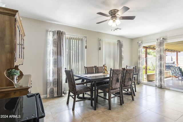 tiled dining space with ceiling fan