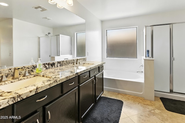 11959 W Vernon Ave, Avondale, AZ 85392 - full bathroom with a garden tub, visible vents, a sink, and a stall shower