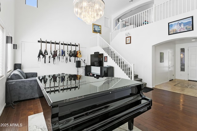 11959 W Vernon Ave, Avondale, AZ 85392 - interior space with wood-type flooring, arched walkways, a high ceiling, and a chandelier