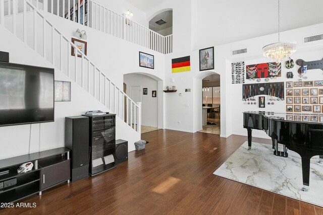 11959 W Vernon Ave, Avondale, AZ 85392 - living area featuring visible vents, a chandelier, wood finished floors, stairway, and arched walkways