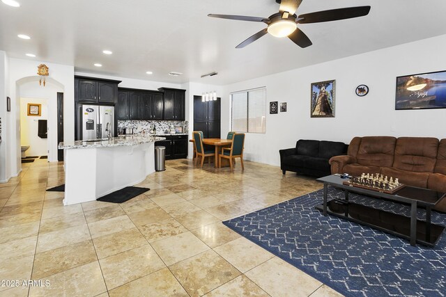 11959 W Vernon Ave, Avondale, AZ 85392 - kitchen with open floor plan, backsplash, stainless steel fridge, and a ceiling fan