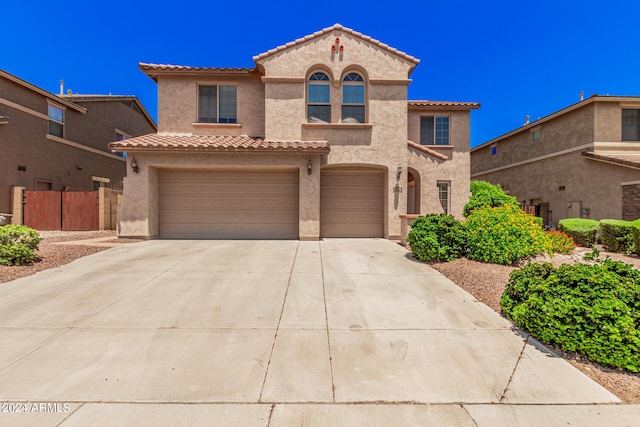 mediterranean / spanish-style house with a garage