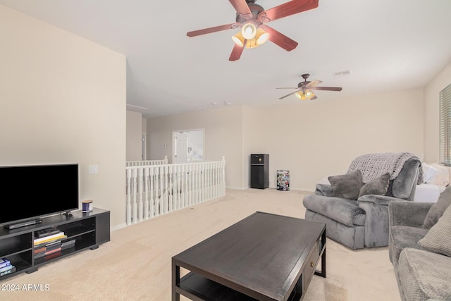 carpeted living room with ceiling fan