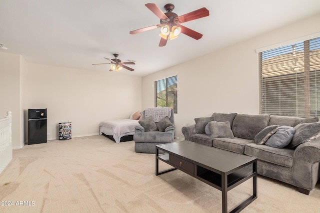 living room featuring light carpet and ceiling fan