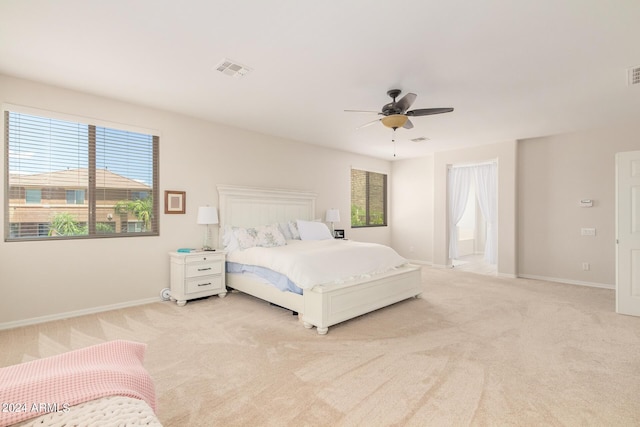 bedroom with light colored carpet and ceiling fan