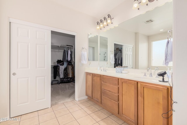 bathroom with tile patterned floors and vanity