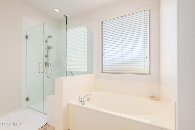 bathroom with tile patterned flooring and independent shower and bath