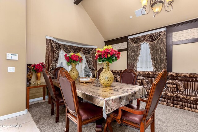 tiled dining area featuring lofted ceiling with beams and a notable chandelier