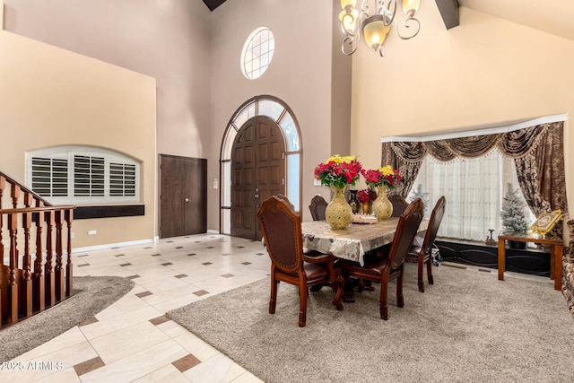 dining area with beamed ceiling, light tile patterned floors, a towering ceiling, and an inviting chandelier