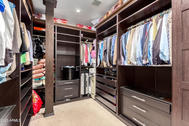 spacious closet featuring light carpet