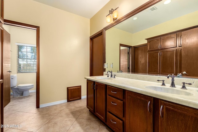 bathroom with tile patterned floors, vanity, and toilet