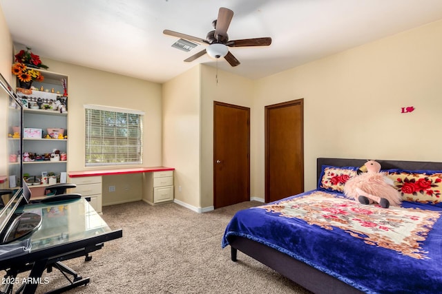 carpeted bedroom with two closets and ceiling fan