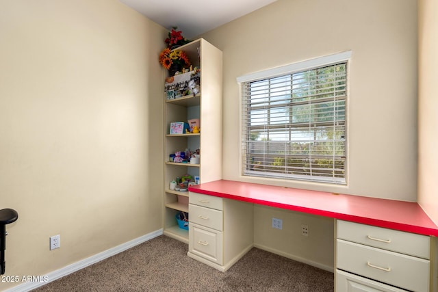 unfurnished office with carpet and built in desk