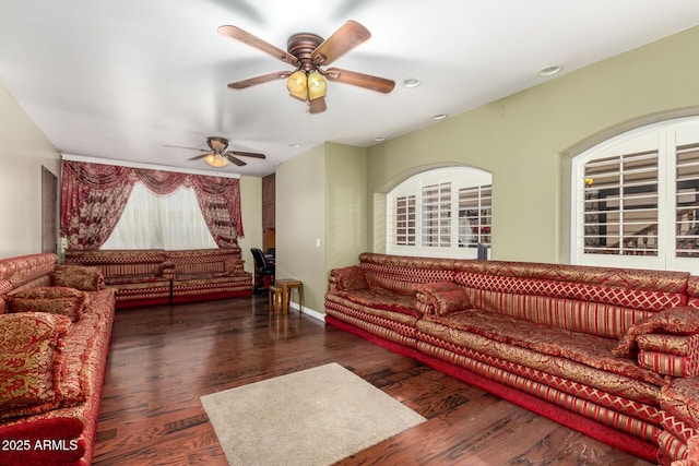 living room featuring ceiling fan, dark hardwood / wood-style flooring, and plenty of natural light