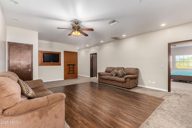 living room featuring carpet and ceiling fan