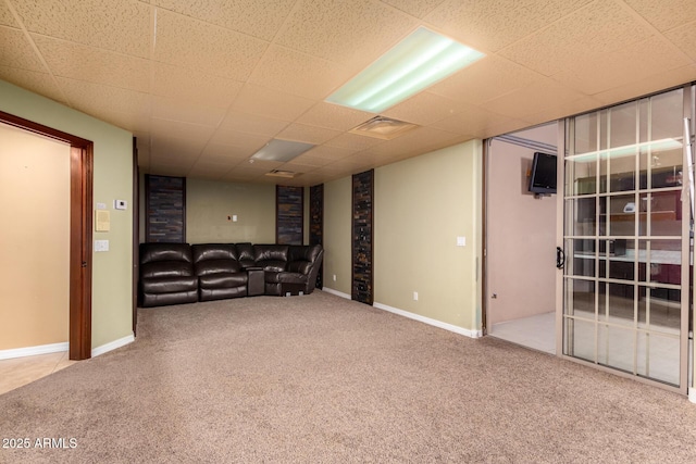 basement with carpet flooring and a drop ceiling