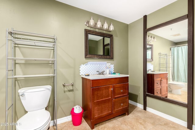 bathroom featuring tile patterned flooring, vanity, and toilet