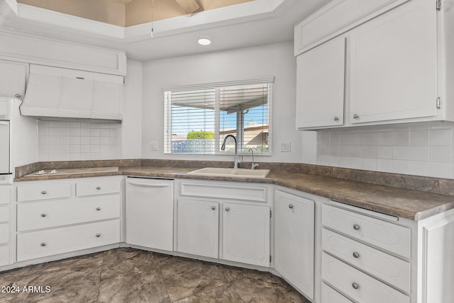 kitchen featuring sink, ventilation hood, white cabinets, white appliances, and backsplash