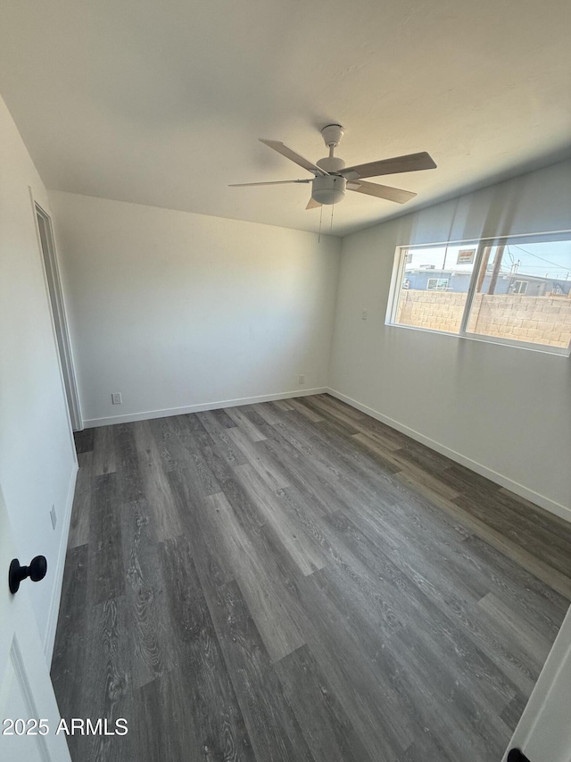 3824 W Puget Ave, Phoenix, AZ 85051 - spare room with a ceiling fan, dark wood-style floors, and plenty of natural light