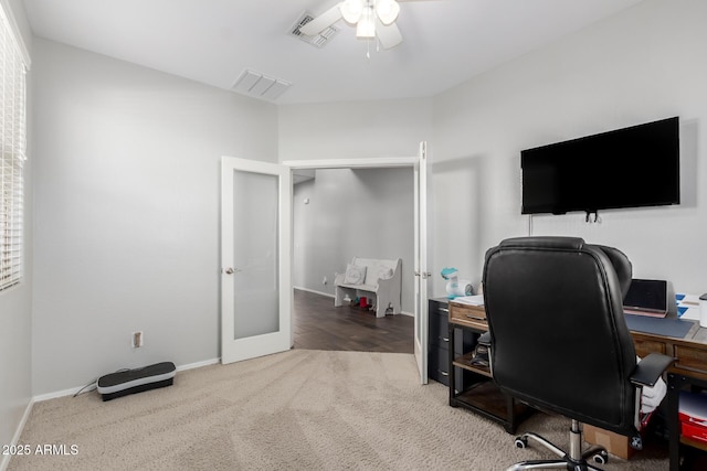 carpeted office space featuring ceiling fan and french doors