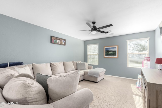 carpeted living room with ceiling fan and a wealth of natural light