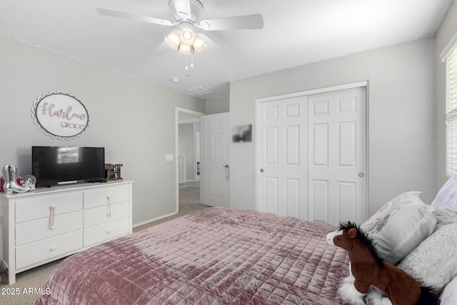 carpeted bedroom with ceiling fan and a closet