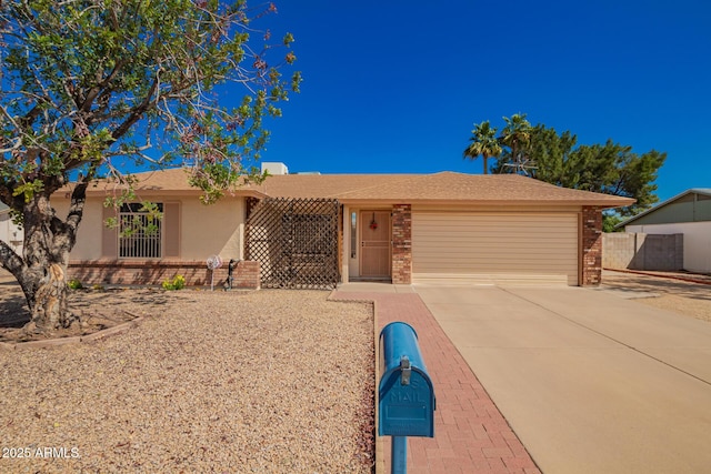 ranch-style home featuring brick siding, an attached garage, fence, stucco siding, and driveway