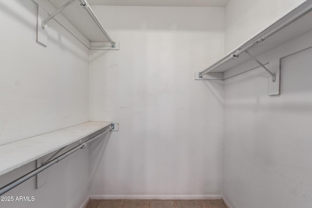 spacious closet with light tile patterned floors