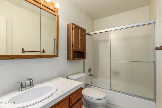 bathroom featuring enclosed tub / shower combo, decorative backsplash, toilet, and vanity