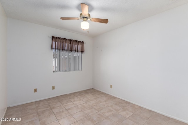 unfurnished room featuring baseboards and a ceiling fan