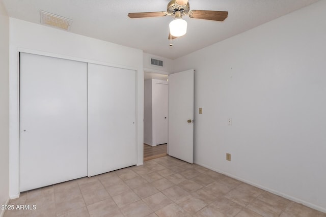 unfurnished bedroom with a closet, visible vents, and a ceiling fan