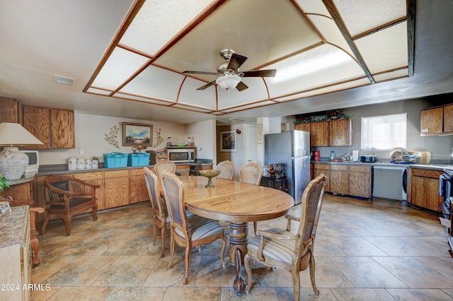 dining space with light tile floors and ceiling fan