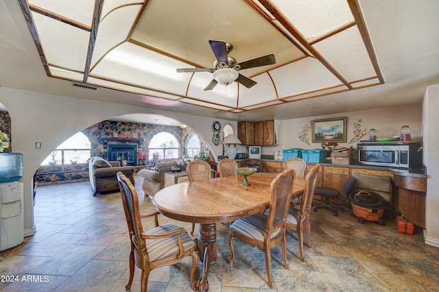 tiled dining area featuring ceiling fan