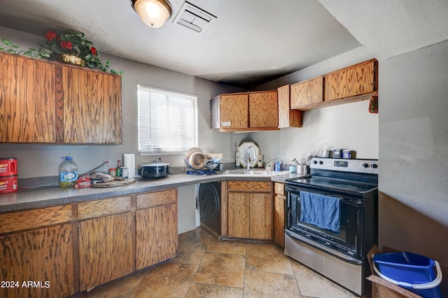 kitchen featuring sink, light tile floors, and electric range