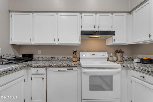 kitchen featuring white cabinets, white appliances, and light stone countertops