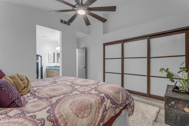 bedroom featuring ensuite bathroom, vaulted ceiling, ceiling fan, and light hardwood / wood-style floors