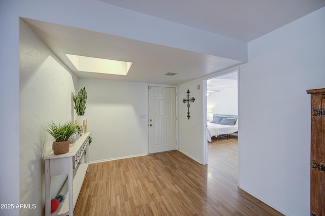 2505 E Desert Cactus St, Phoenix, AZ 85032 - entrance foyer with a skylight, light wood-type flooring, and baseboards