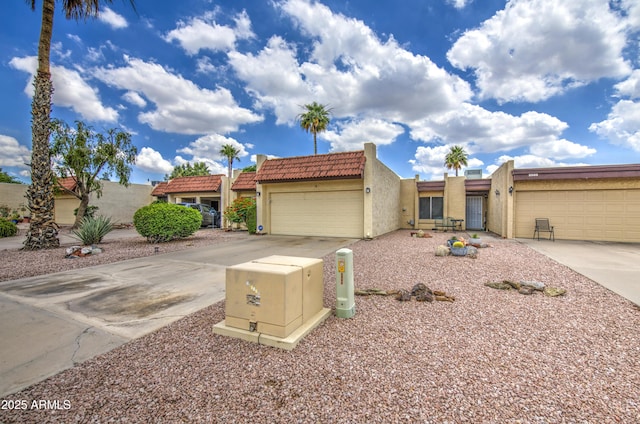 2505 E Desert Cactus St, Phoenix, AZ 85032 - townhome / multi-family property featuring stucco siding, a tiled roof, concrete driveway, and a garage