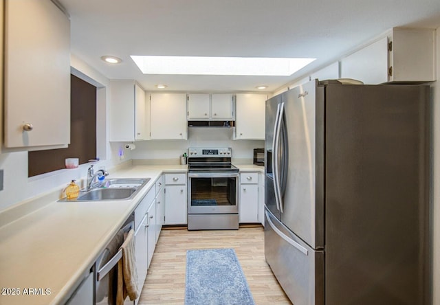 2505 E Desert Cactus St, Phoenix, AZ 85032 - kitchen featuring stainless steel appliances, a skylight, a sink, range hood, and light countertops