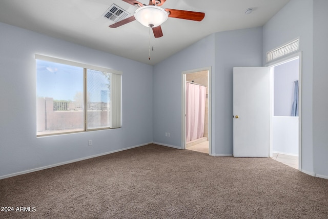 carpeted spare room with ceiling fan and lofted ceiling