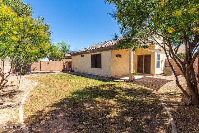 rear view of property featuring a yard