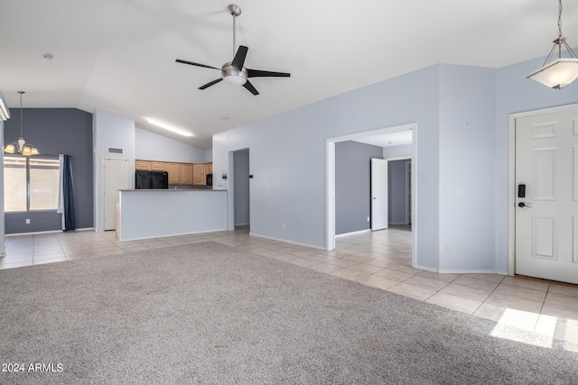 unfurnished living room featuring ceiling fan with notable chandelier, light colored carpet, and lofted ceiling