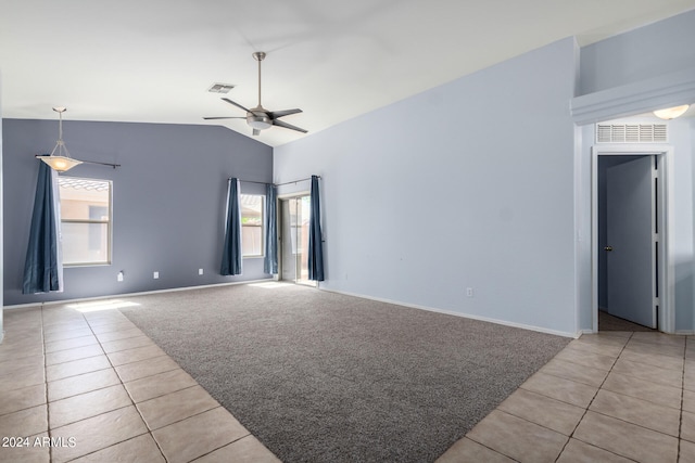 carpeted spare room featuring high vaulted ceiling and ceiling fan