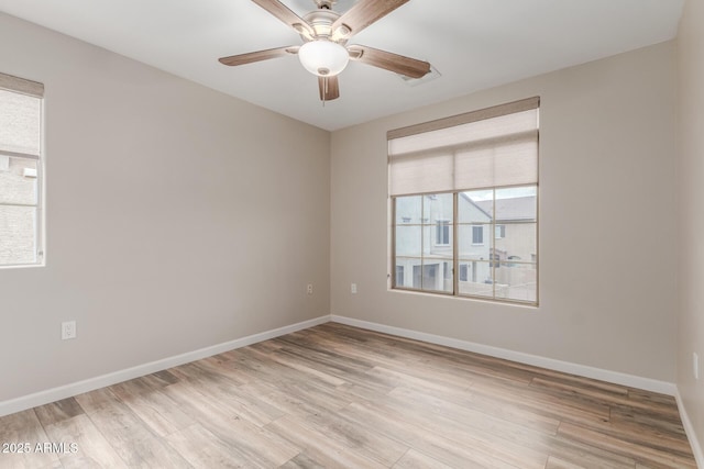 unfurnished room featuring ceiling fan, baseboards, and light wood-style floors
