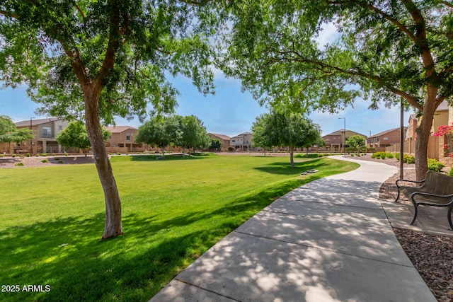 view of home's community featuring a residential view and a lawn