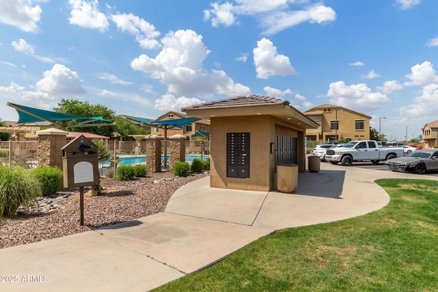 view of property's community with mail area and fence