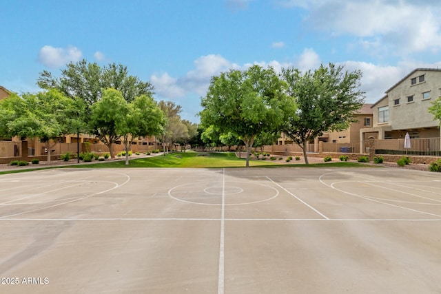 view of basketball court with community basketball court and fence