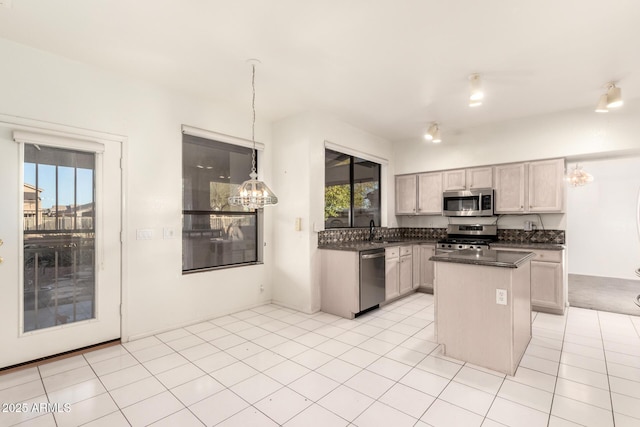 20435 N 39th Dr, Glendale, AZ 85308 - kitchen with a chandelier, stainless steel appliances, dark countertops, a sink, and a center island