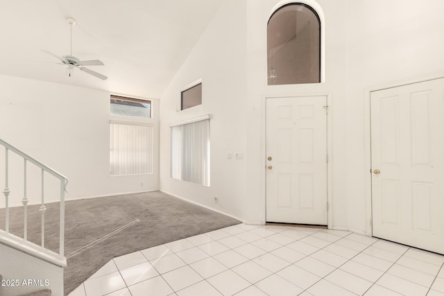 20435 N 39th Dr, Glendale, AZ 85308 - entryway featuring light tile patterned flooring, high vaulted ceiling, stairway, light colored carpet, and ceiling fan