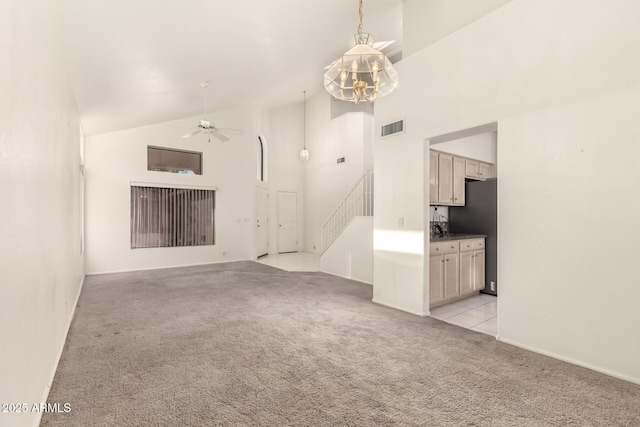 20435 N 39th Dr, Glendale, AZ 85308 - unfurnished living room with stairs, high vaulted ceiling, light carpet, ceiling fan with notable chandelier, and visible vents
